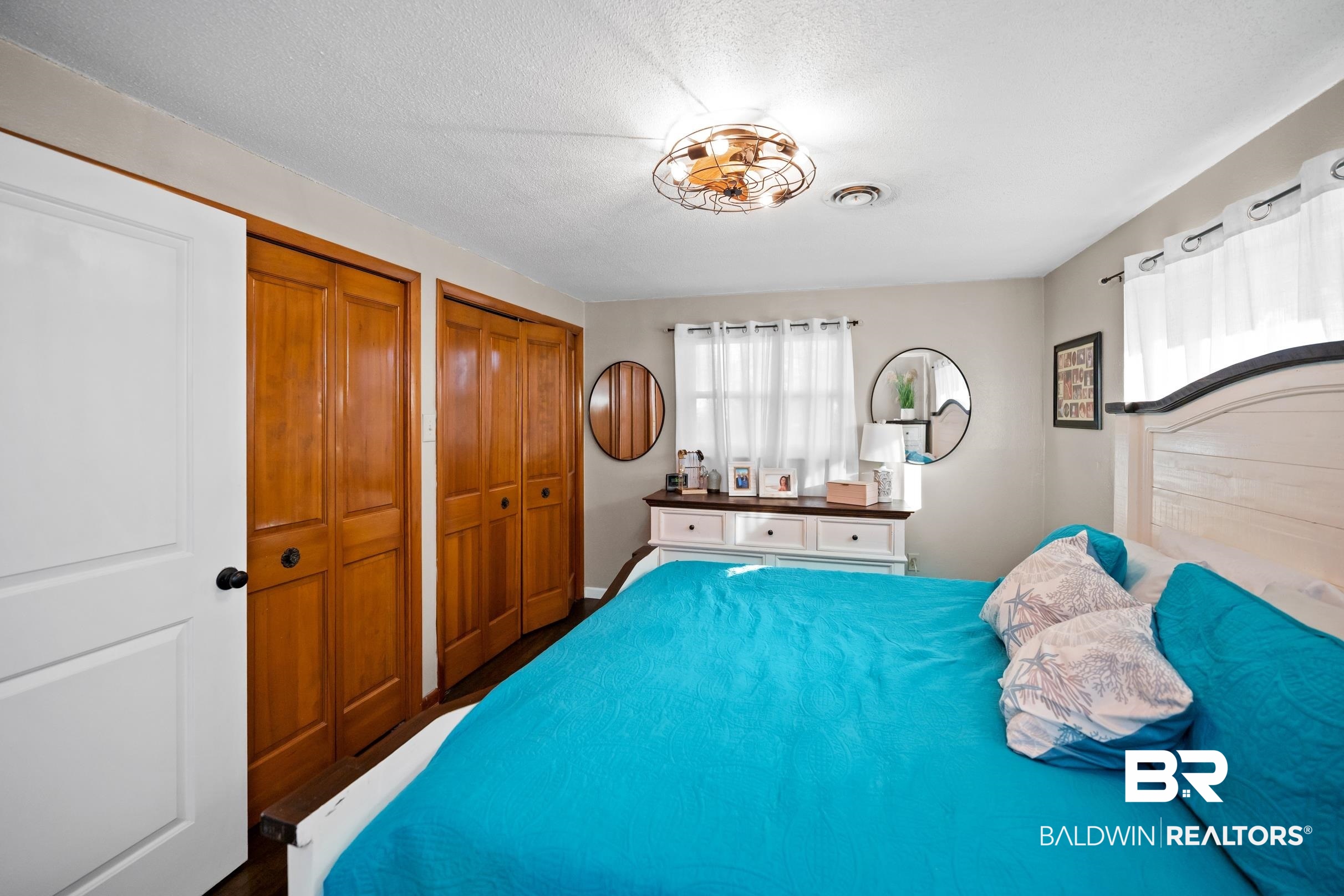 401 West Myrtle Avenue Foley, AL 36535 - Photo 23 of 39 Bedroom featuring two closets and a textured ceiling