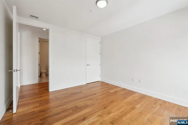 an empty room with wooden floor