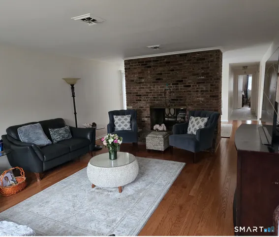 a living room with furniture and a fireplace