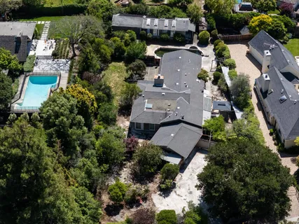 an aerial view of multiple houses with yard