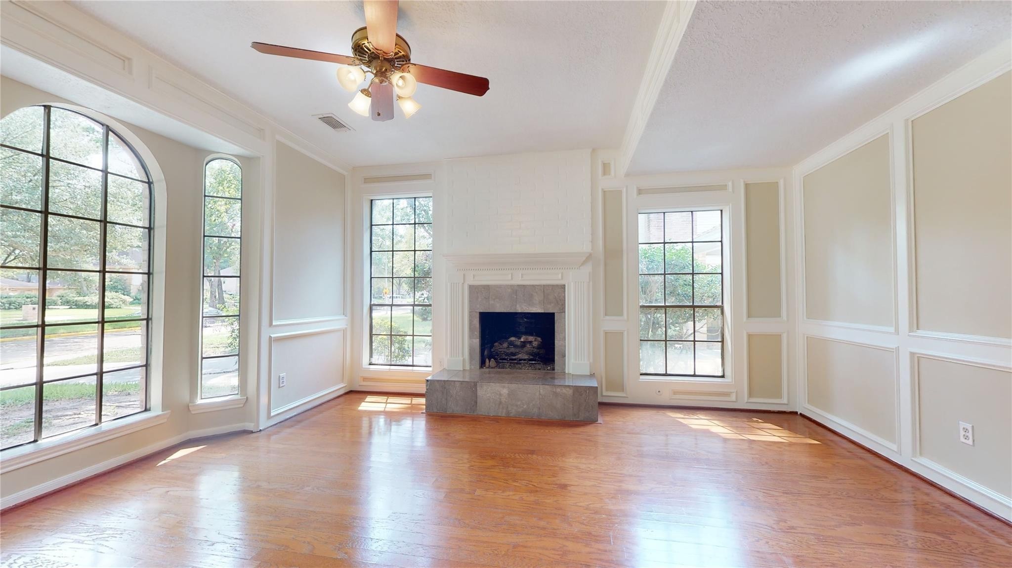 3510 Cypresswood Drive Spring, TX 77388 - Photo 12 of 36 wooden floor fireplace and windows in an empty room