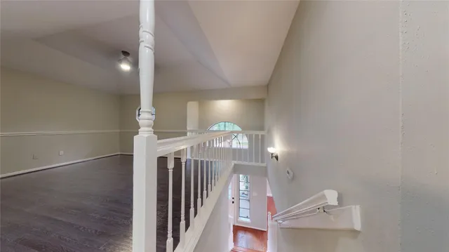 a view of a big room with windows and chandelier