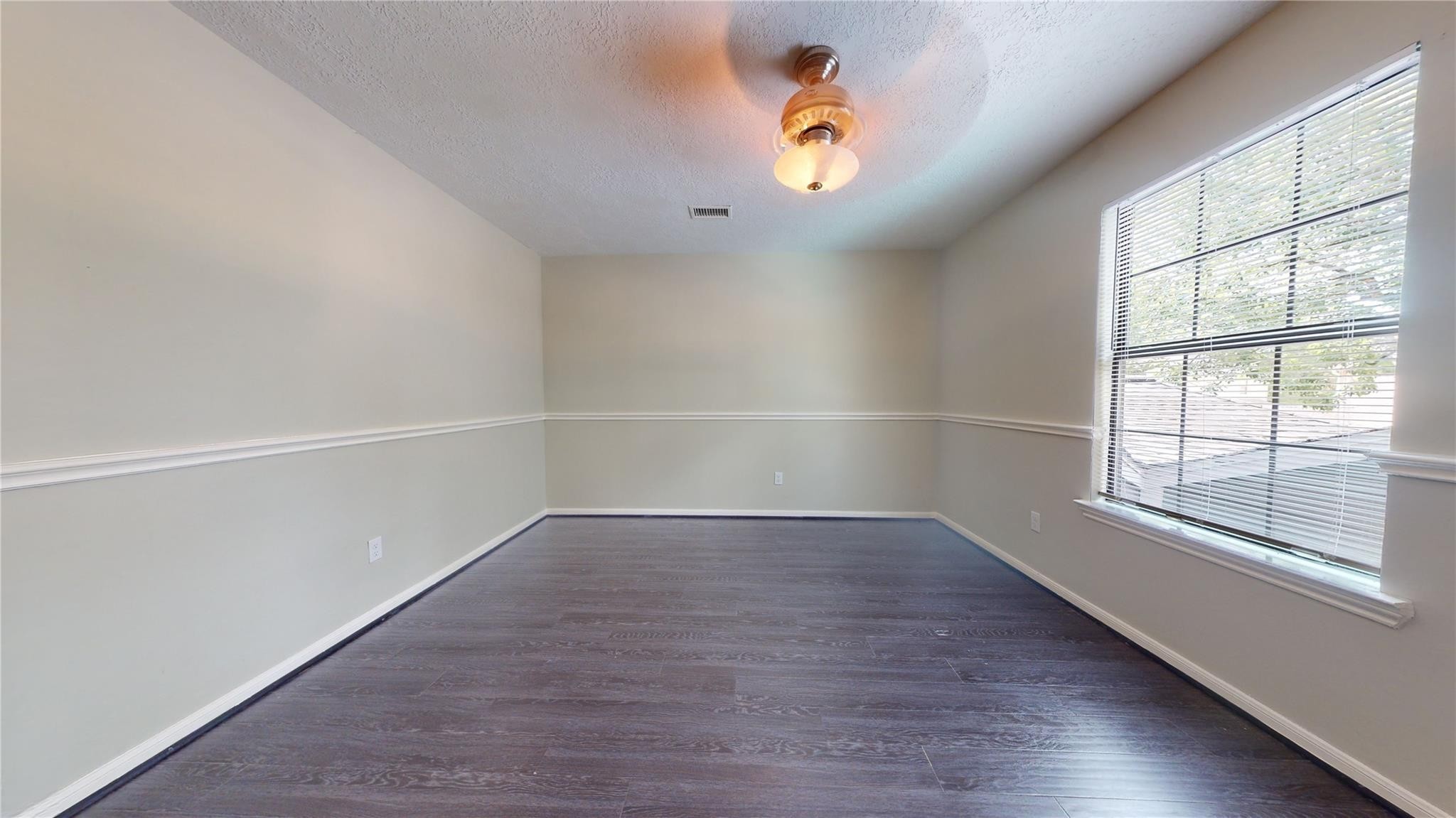 3510 Cypresswood Drive Spring, TX 77388 - Photo 22 of 36 an empty room with wooden floor and windows