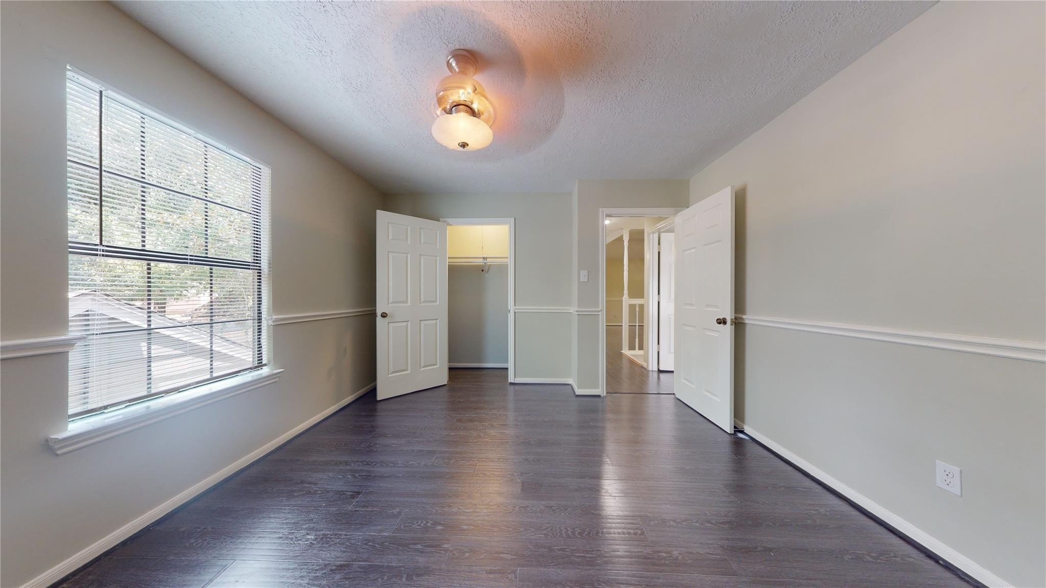 3510 Cypresswood Drive Spring, TX 77388 - Photo 24 of 36 an empty room with wooden floor and windows