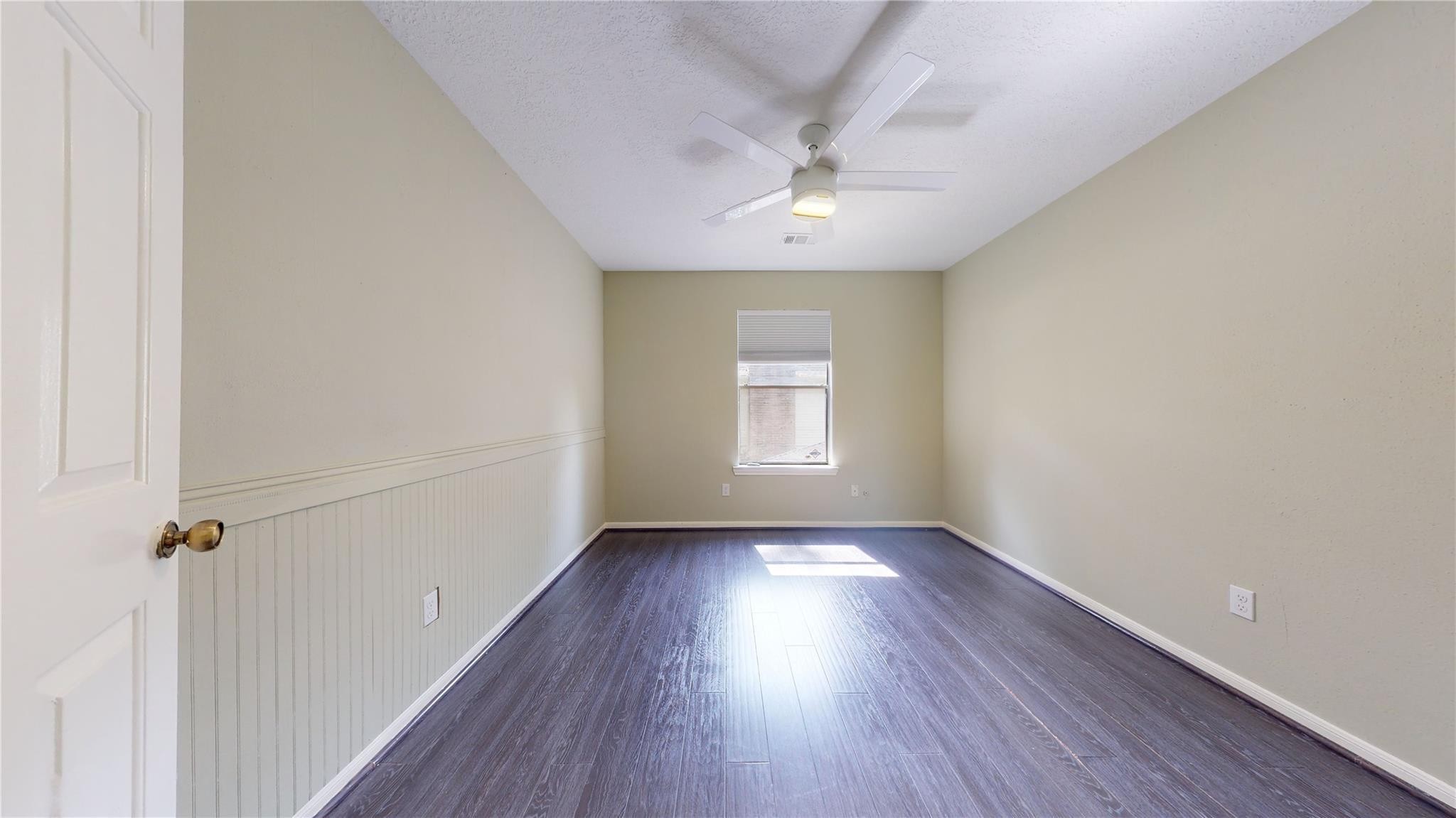 3510 Cypresswood Drive Spring, TX 77388 - Photo 27 of 36 an empty room with wooden floor fan and windows