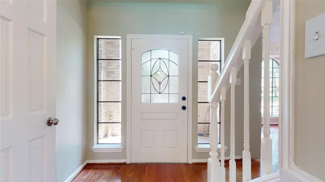 a view of front door with wooden floor