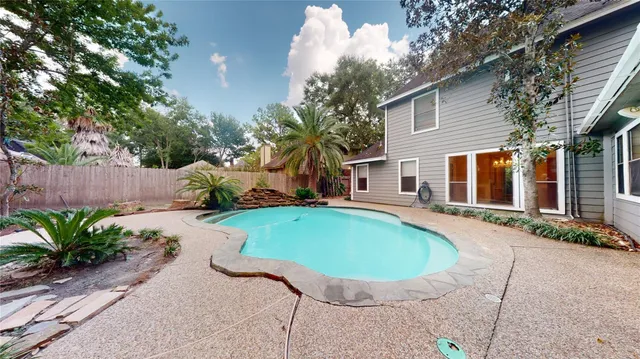 front view of a house with a tree in a yard