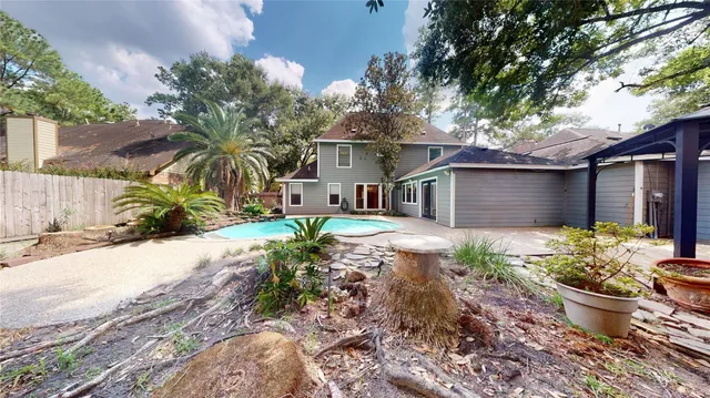a backyard of a house with a garden and tree
