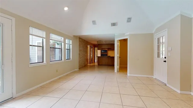 a view of an empty room with window and cabinet
