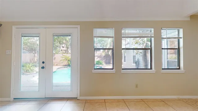 an empty room with windows and closet