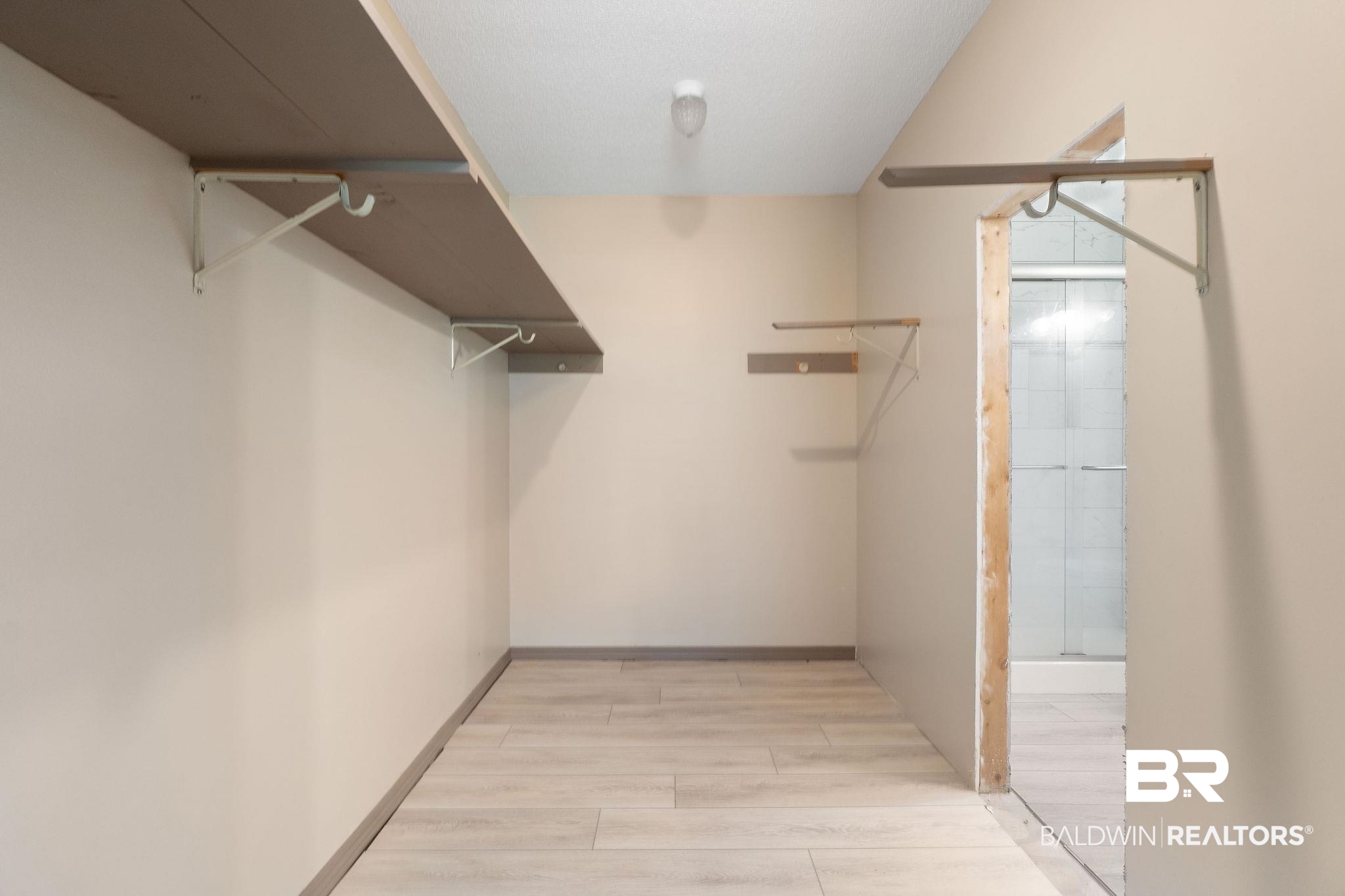 27300 C R Watson Road Robertsdale, AL 36567 - Photo 15 of 35 Walk in closet featuring light hardwood / wood-style floors