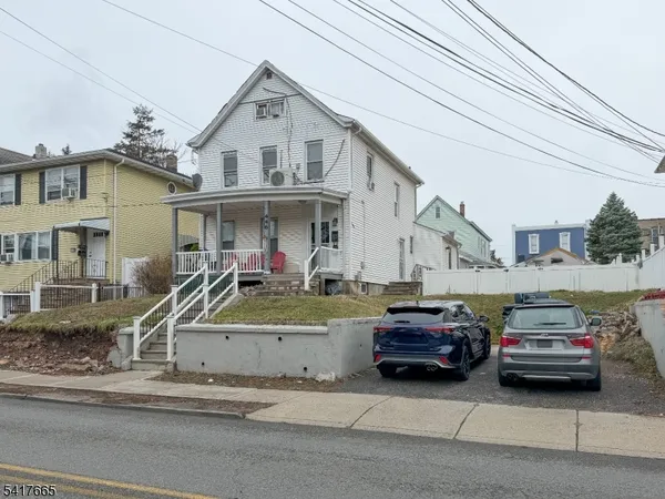 a view of a car parked in front of a house