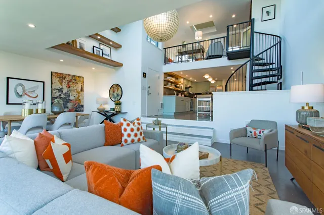 a living room with furniture kitchen view and a chandelier