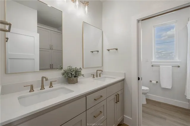 a bathroom with a double vanity sink and mirror