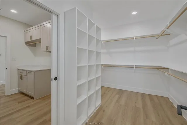 a view of walk in closet with empty racks