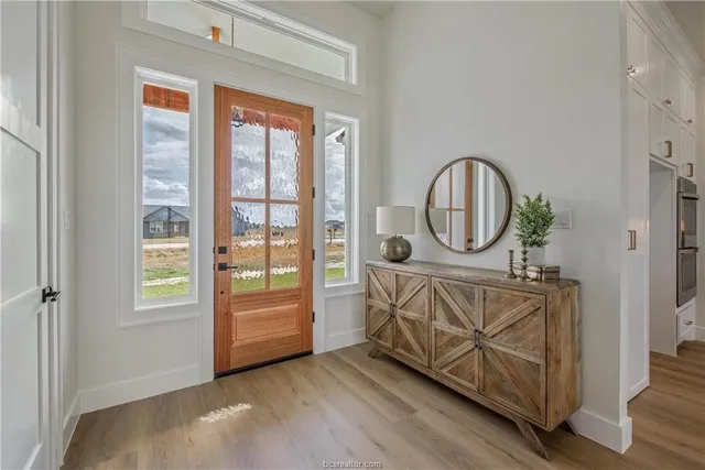 a living room with furniture a wooden floor and a window