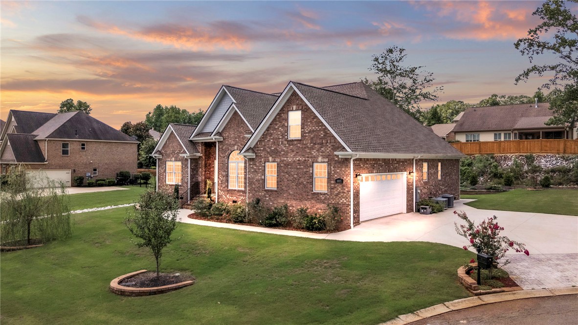 1015 Winmar Drive Anderson, SC 29621 - Photo 1 of 49 This classic brick residence boasts a spacious driveway and well-maintained landscaping under a vibrant sky.