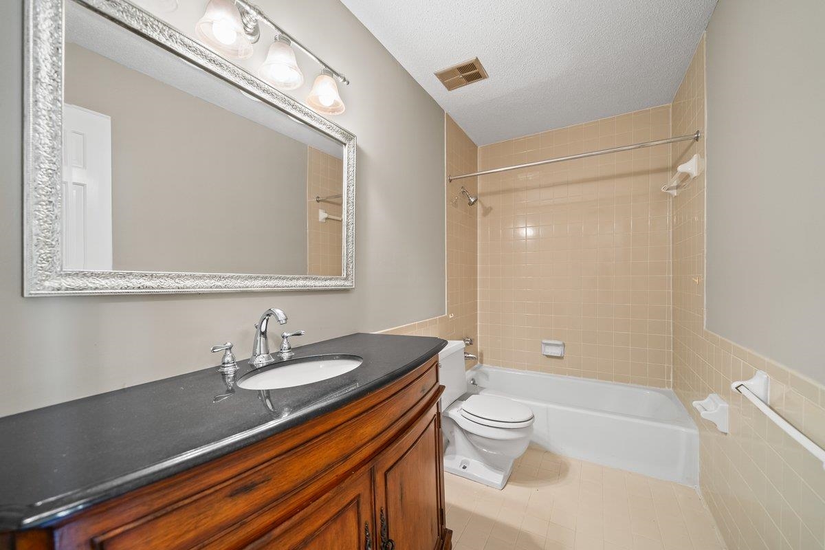 6942 Amberly Road, Unit 6942 Memphis, TN 38119 - Photo 18 of 23 a bathroom with a sink a toilet and a large mirror