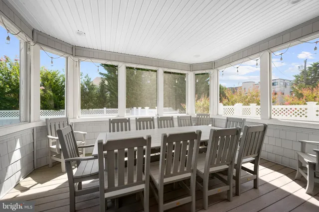 a view of a dining room with furniture large windows and wooden floor