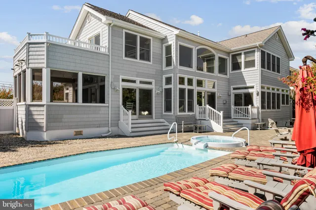 a view of a house with swimming pool and sitting area