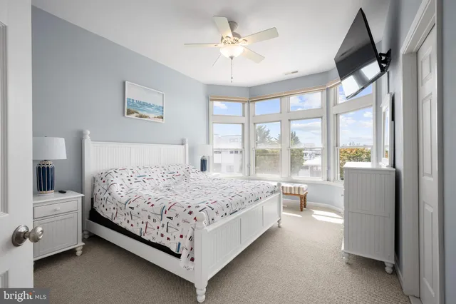 a bathroom with a granite countertop sink toilet a mirror and shower