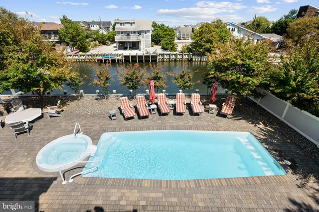 a swimming pool with outdoor seating and yard