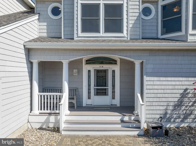 a living room with furniture a fireplace and a large window