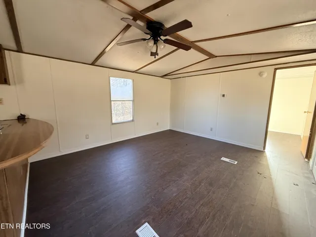 a view of a room with wooden floor and window