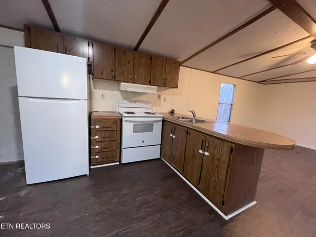 a kitchen with stainless steel appliances a refrigerator and a sink