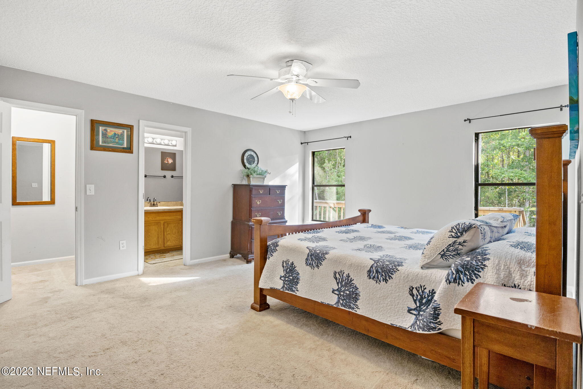 944 North Lilac Loop St. Johns, FL 32259 - Photo 17 of 32 a bed sitting in a bedroom next to a window