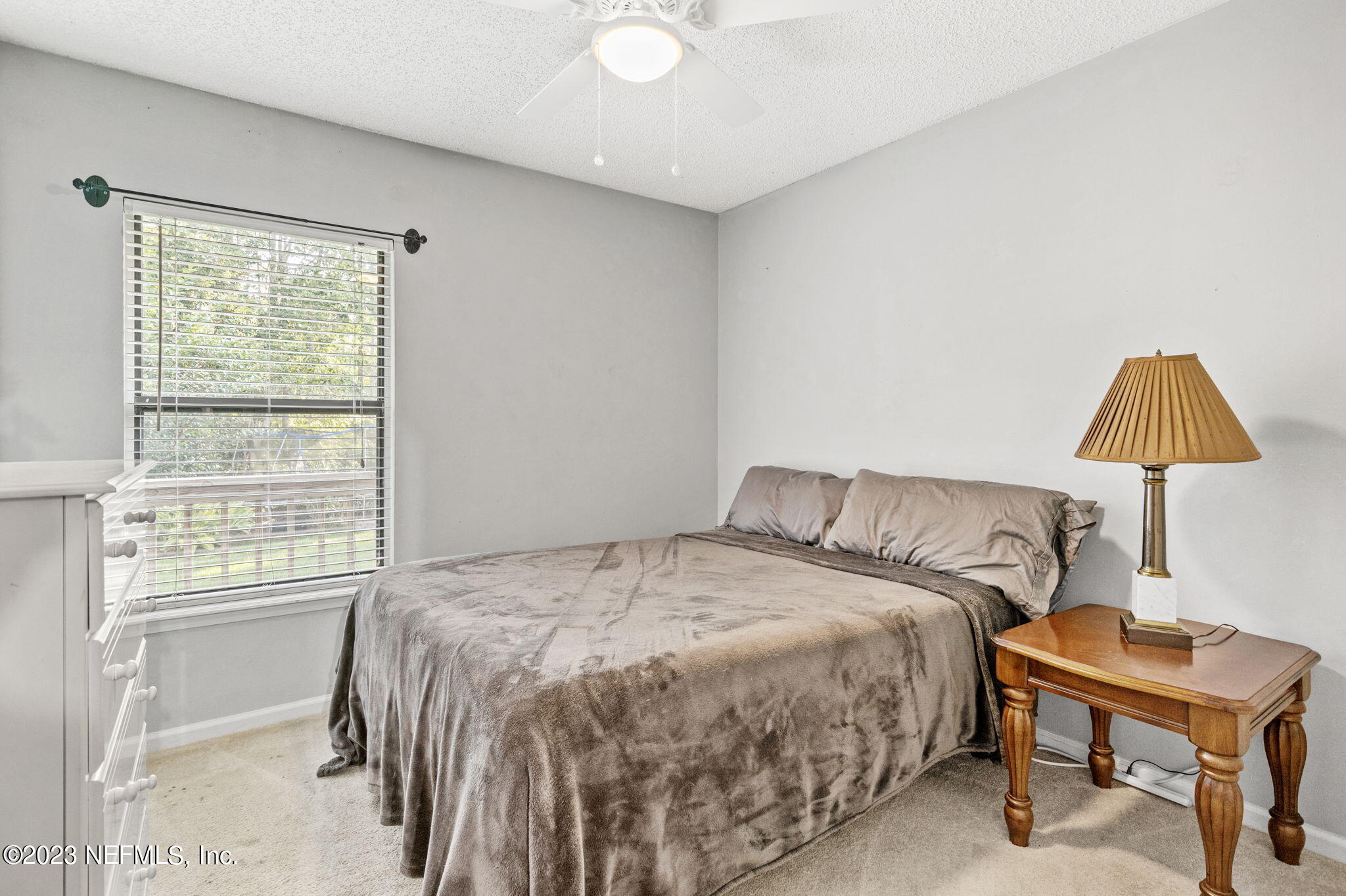 944 North Lilac Loop St. Johns, FL 32259 - Photo 23 of 32 a bedroom with a bed a lamp and a window