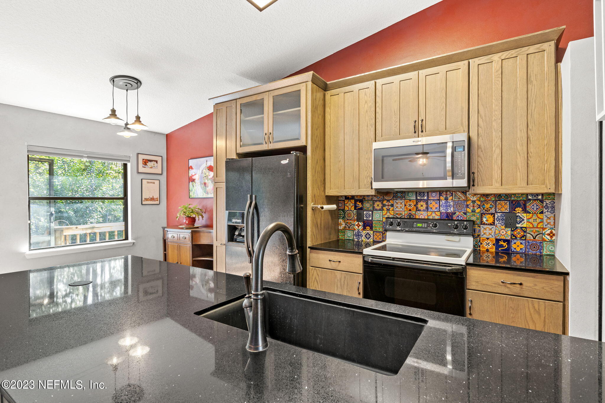 944 North Lilac Loop St. Johns, FL 32259 - Photo 7 of 32 a kitchen with stainless steel appliances granite countertop a stove a sink and a refrigerator
