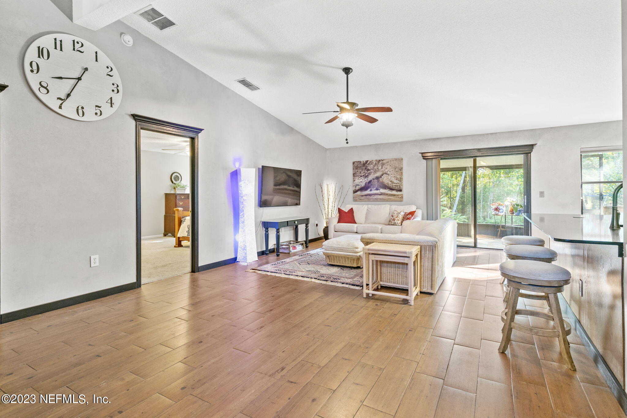 944 North Lilac Loop St. Johns, FL 32259 - Photo 8 of 32 a living room with furniture a clock and a window