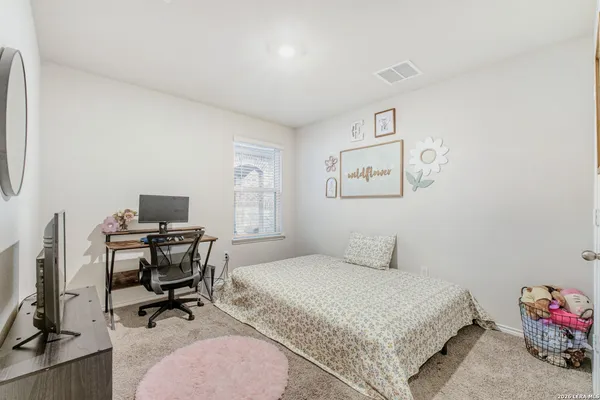 a bedroom with a workspace