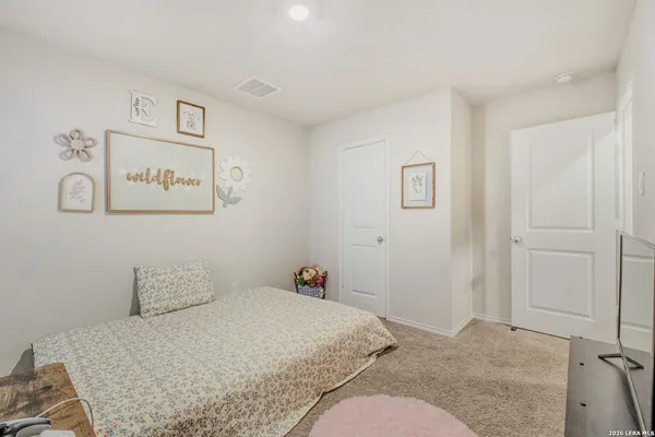 a bedroom with a bed and cabinets