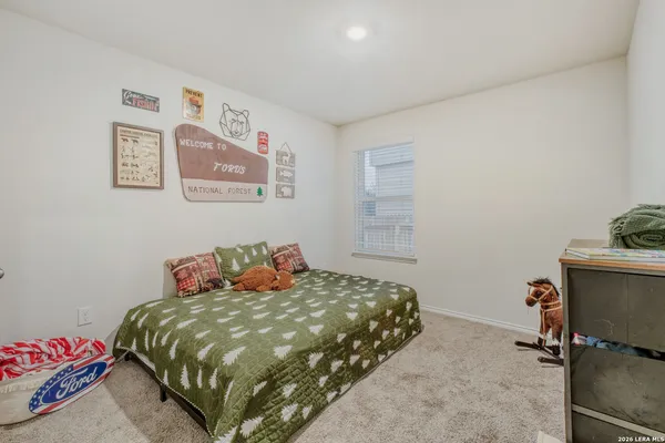 a bedroom with a bed and a desk