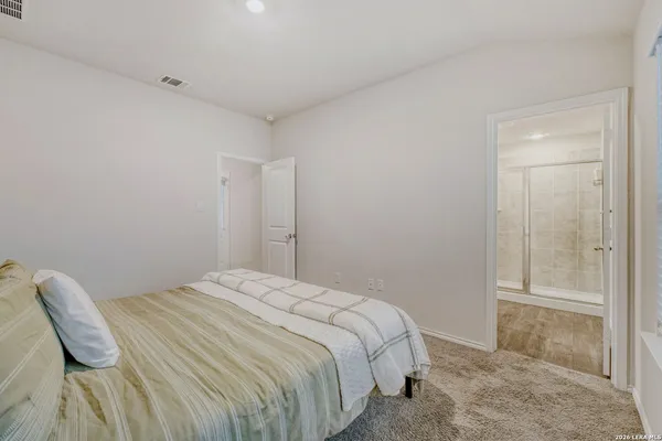 a bedroom with a bed and with a chair