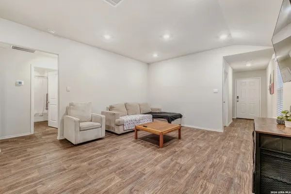 a living room with furniture and a wooden floor