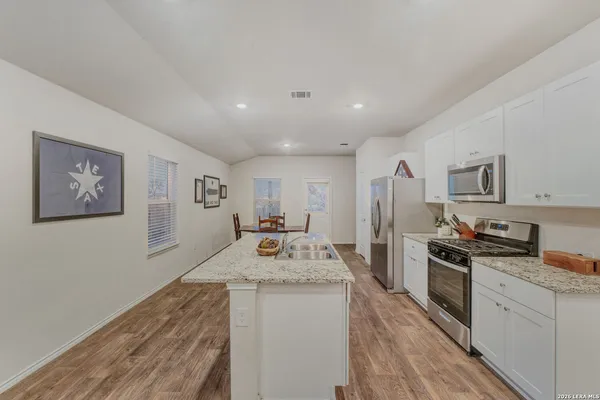 a kitchen with a sink stove and refrigerator