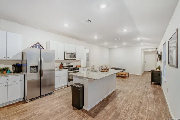 a kitchen with refrigerator and cabinets