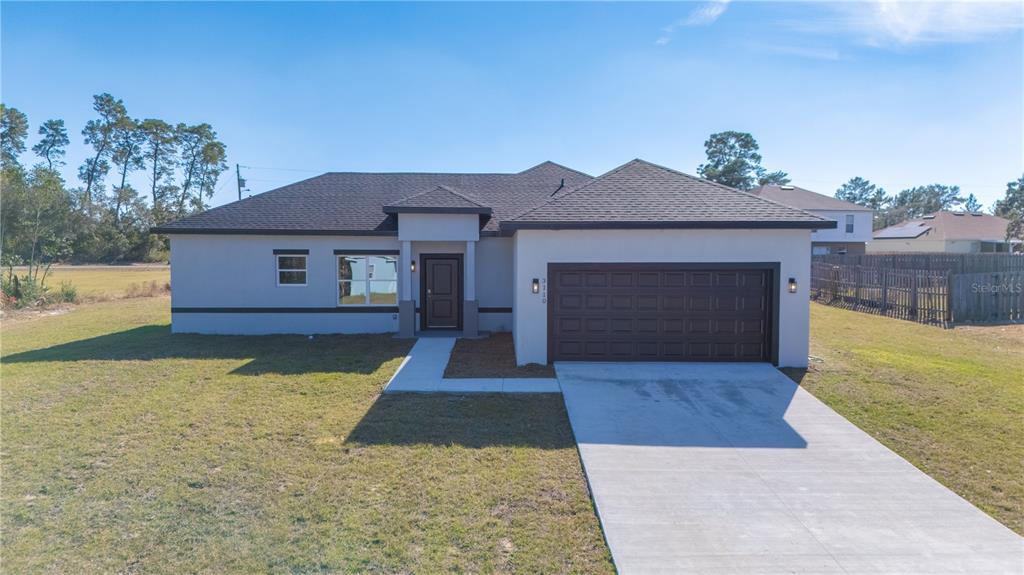 3110 Southwest 127th Lane Road Ocala, FL 34473 - Photo 1 of 17 a front view of a house with yard