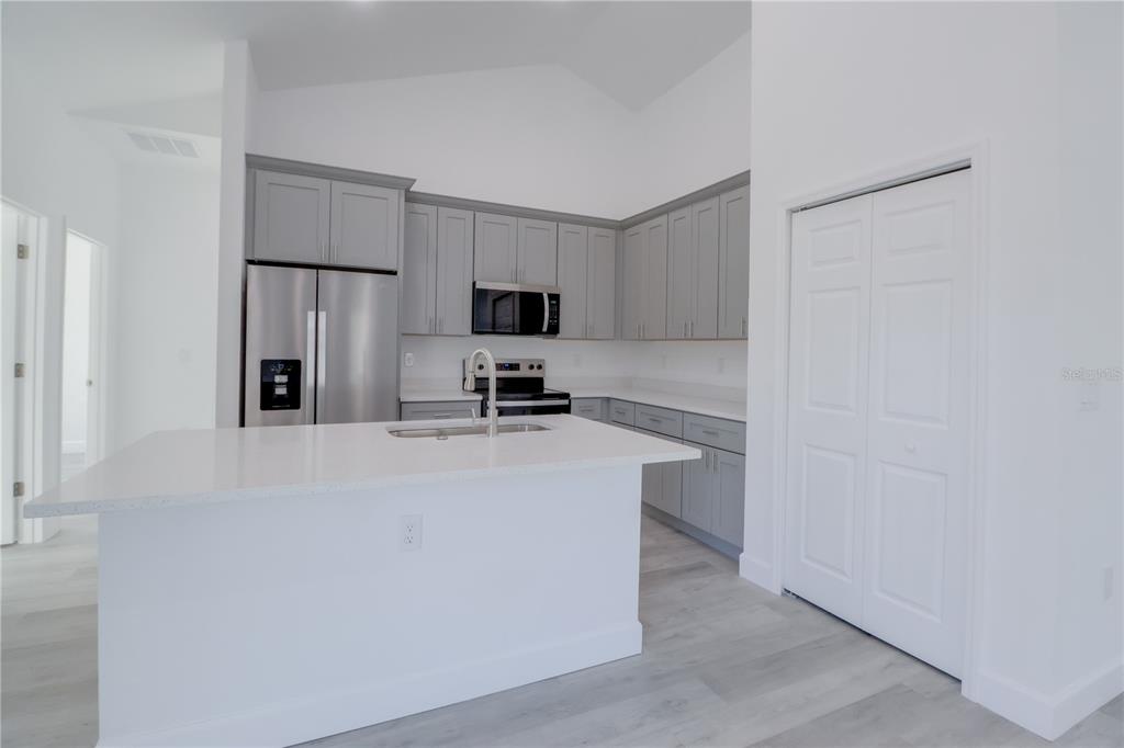3110 Southwest 127th Lane Road Ocala, FL 34473 - Photo 11 of 17 a kitchen with cabinets a microwave and refrigerator