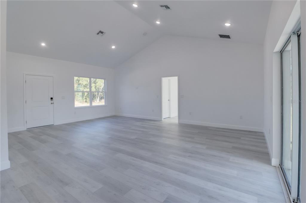 3110 Southwest 127th Lane Road Ocala, FL 34473 - Photo 13 of 17 an empty room with wooden floor and windows