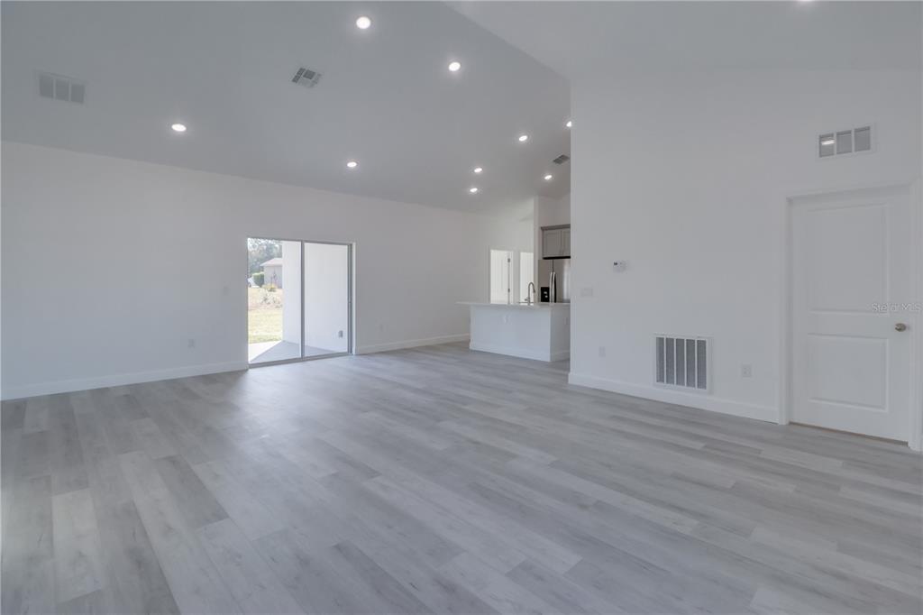 3110 Southwest 127th Lane Road Ocala, FL 34473 - Photo 8 of 17 a view of empty room with wooden floor and windows