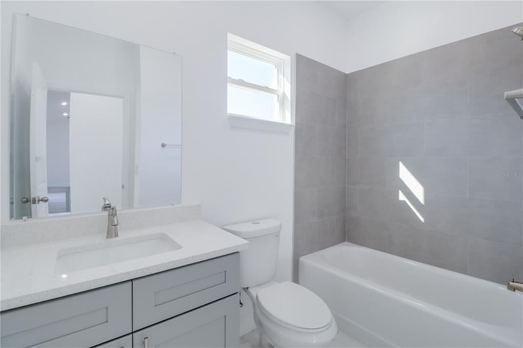 3110 Southwest 127th Lane Road Ocala, FL 34473 - Photo 9 of 17 a bathroom with a sink a toilet and shower