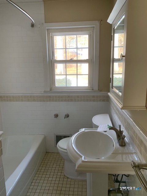 329 Bronson Road Fairfield, CT 06890 - Photo 11 of 25 a bathroom with a sink and a bathtub