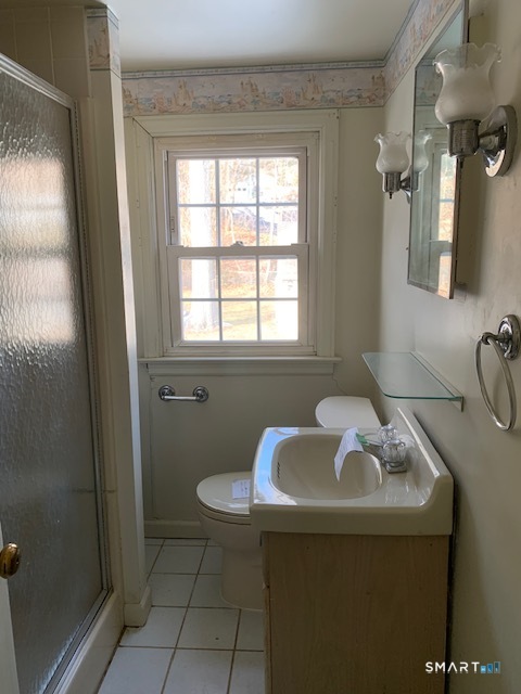 329 Bronson Road Fairfield, CT 06890 - Photo 16 of 25 a bathroom with a sink and a mirror