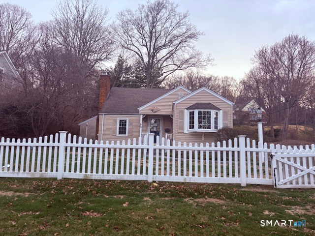 329 Bronson Road Fairfield, CT 06890 - Photo 2 of 25 a front view of a house with a garden