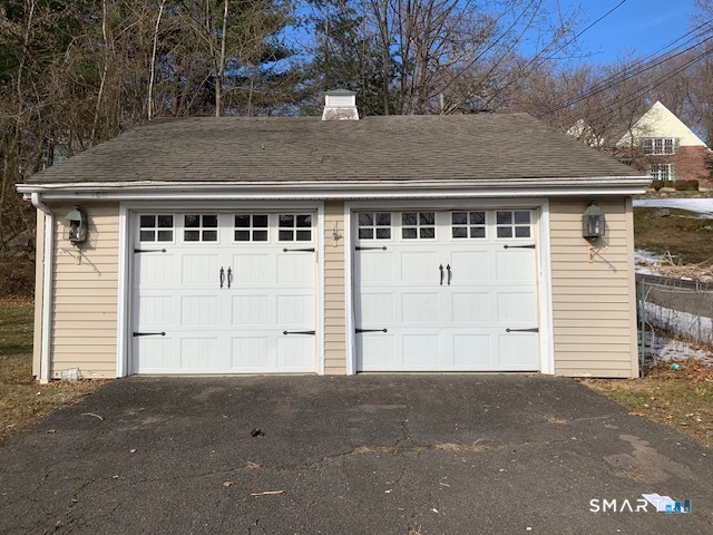 329 Bronson Road Fairfield, CT 06890 - Photo 21 of 25 a front view of a house with a garage