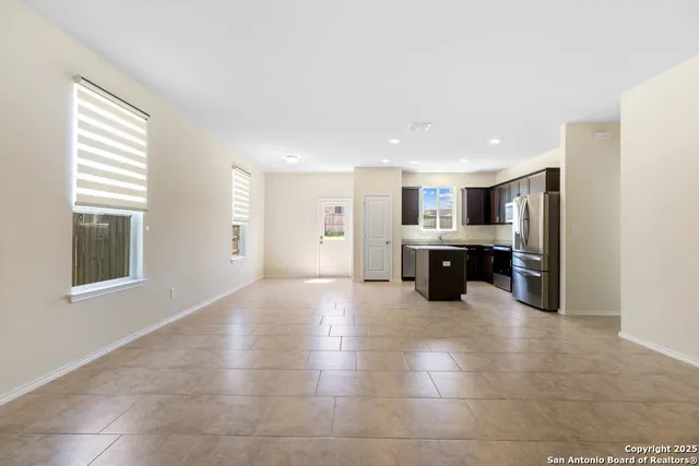 a large kitchen with stainless steel appliances kitchen island granite countertop a large counter top and oven